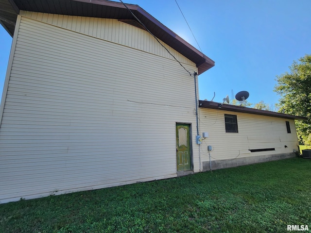 view of side of home with a lawn