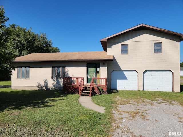 split level home with a garage, a wooden deck, and a front yard