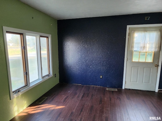 empty room featuring dark hardwood / wood-style flooring