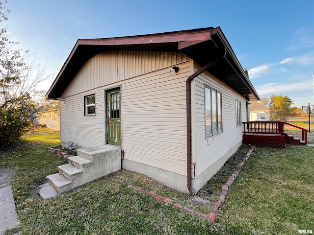 view of home's exterior with a yard and a deck