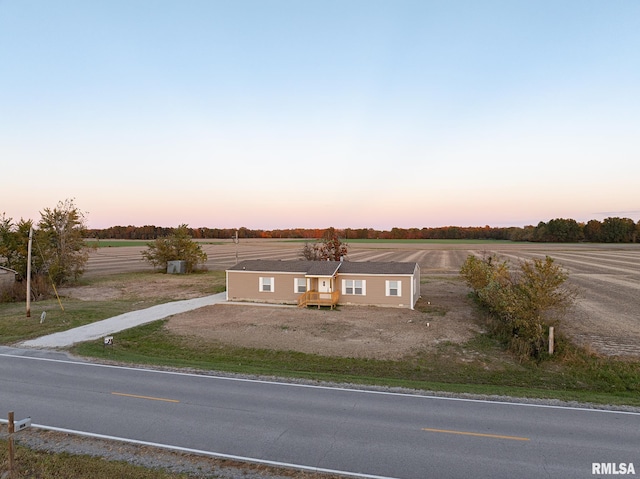 view of front of property with a rural view