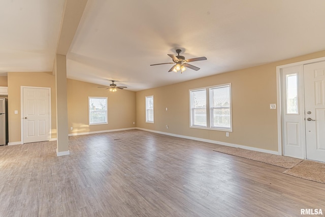 interior space featuring vaulted ceiling, ceiling fan, hardwood / wood-style flooring, and plenty of natural light