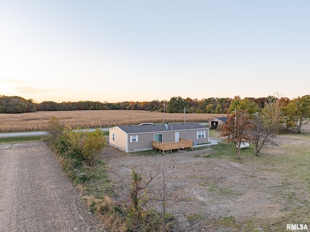 aerial view at dusk featuring a rural view