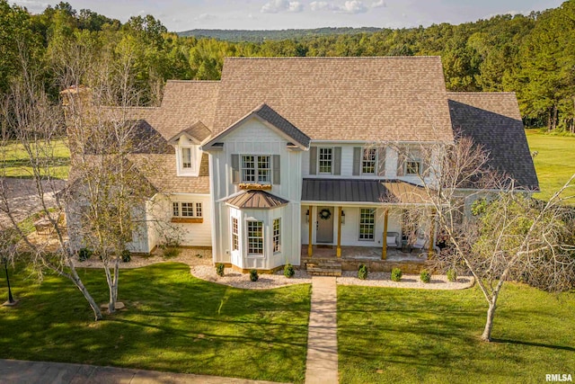 view of front of house with covered porch and a front yard