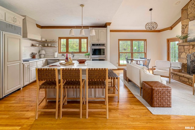 kitchen with appliances with stainless steel finishes, pendant lighting, and plenty of natural light