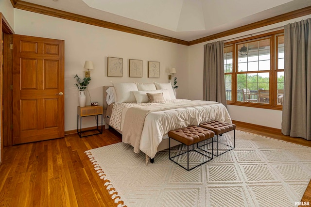 bedroom with hardwood / wood-style floors and crown molding