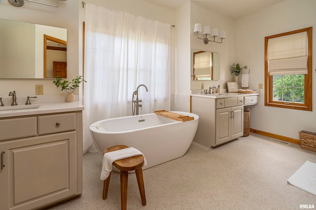 bathroom with vanity and a bathtub