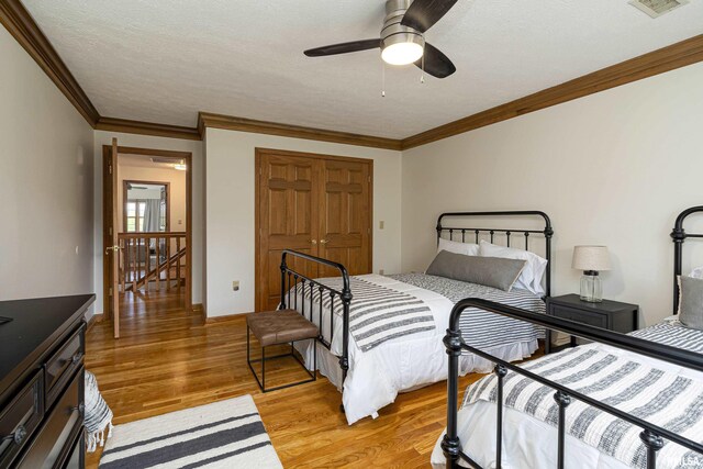 5345 State Route 127th Hwy, Cobden, IL 62920 - bedroom featuring light wood-style floors, crown molding, a closet, a textured ceiling, and ceiling fan