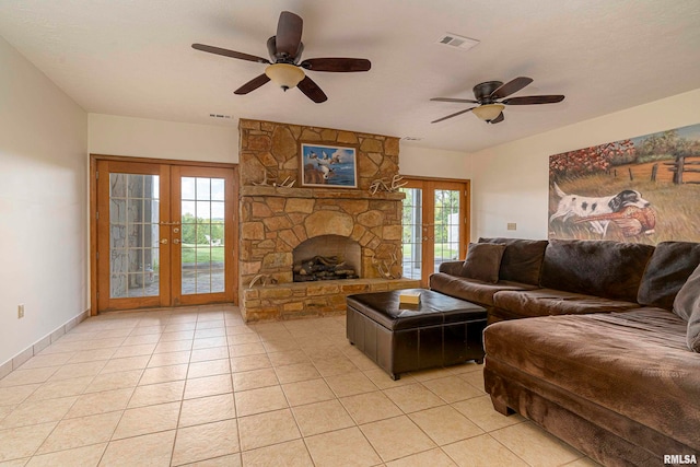 tiled living room with french doors, a fireplace, and ceiling fan