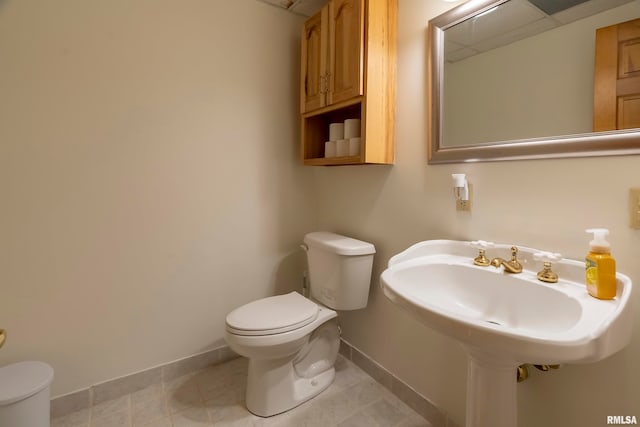 bathroom with toilet and tile patterned flooring