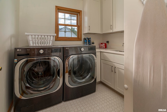 washroom featuring cabinets, washer and dryer, and sink