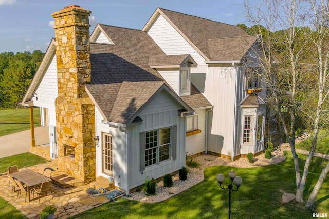 rear view of property featuring a patio area and a lawn