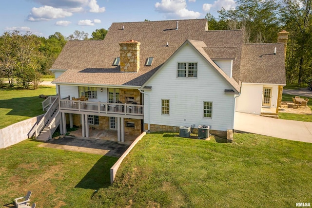 rear view of house featuring a patio, a yard, and central air condition unit