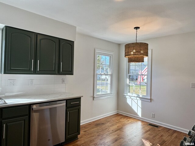 kitchen with tasteful backsplash, baseboards, visible vents, dishwasher, and wood finished floors