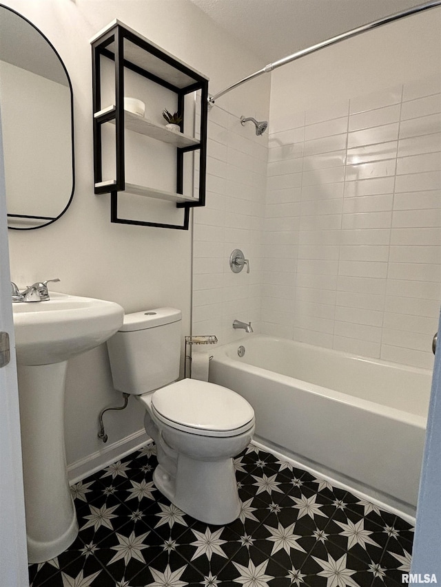 full bathroom with shower / washtub combination, baseboards, toilet, and tile patterned floors