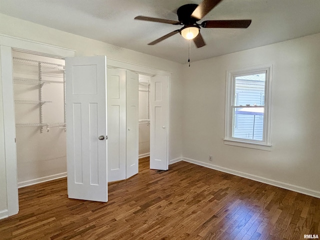 unfurnished bedroom with ceiling fan, a closet, wood finished floors, and baseboards