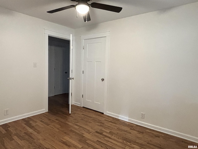 empty room with a ceiling fan, baseboards, and wood finished floors