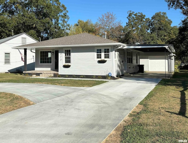 single story home with a porch, a front lawn, a garage, and a carport