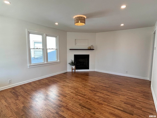 unfurnished living room featuring dark hardwood / wood-style floors