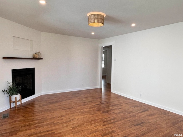 unfurnished living room with dark hardwood / wood-style flooring