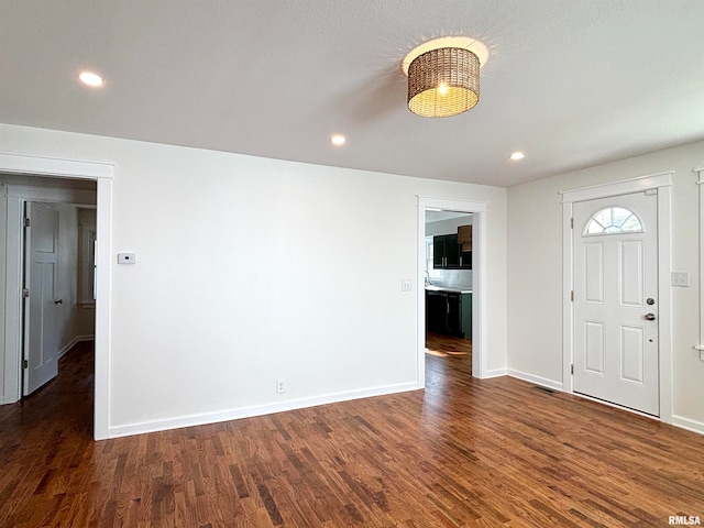 foyer entrance featuring dark hardwood / wood-style floors