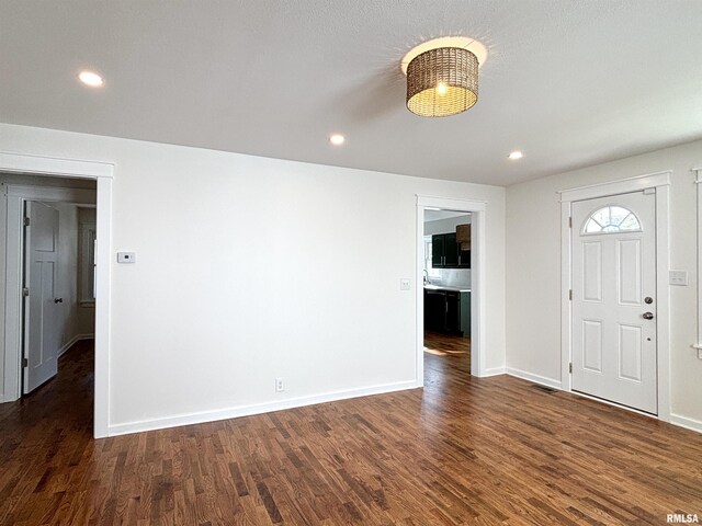 entryway featuring baseboards, wood finished floors, and recessed lighting