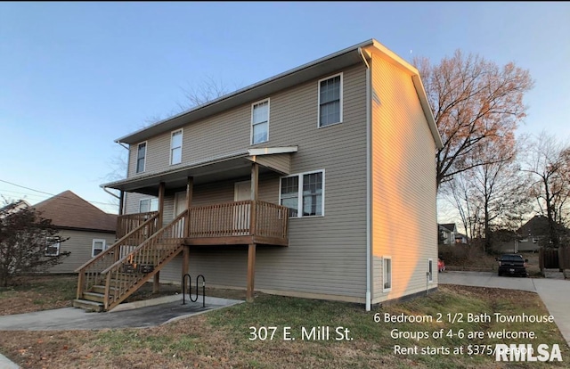 rear view of house featuring a wooden deck