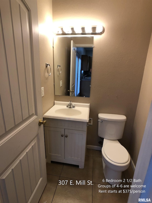 bathroom featuring vanity, toilet, and tile patterned floors