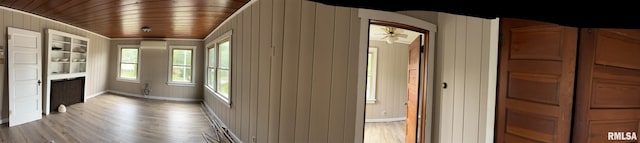 corridor featuring wood ceiling, wood-type flooring, and wooden walls