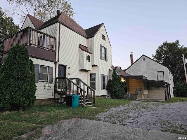 back of property featuring a balcony