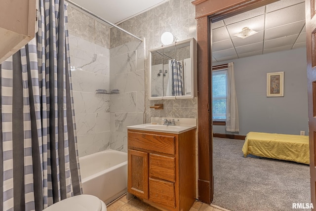 full bathroom featuring vanity, toilet, shower / bathtub combination with curtain, and tile walls