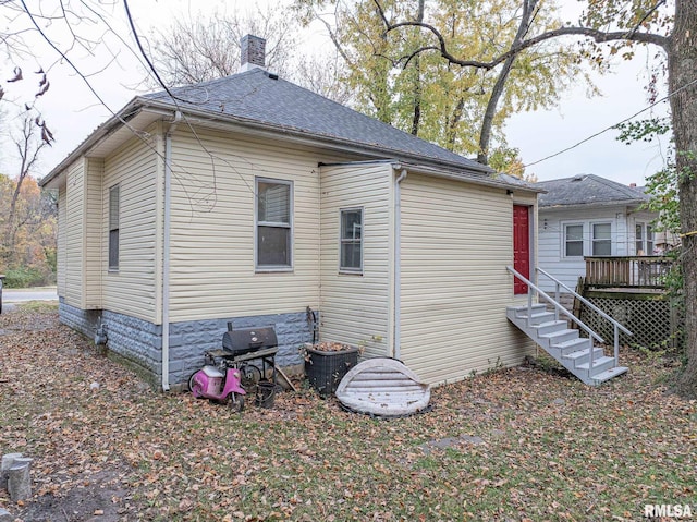 727 N Broadway Ave, Salem, IL 62881 - rear view of property featuring a deck, a chimney, and a shingled roof