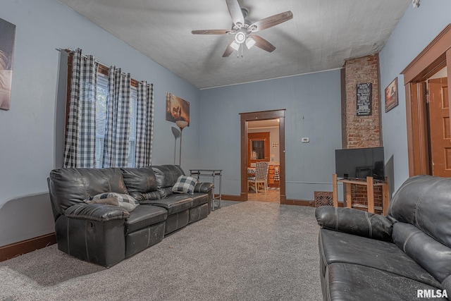 living room with a textured ceiling, carpet flooring, and ceiling fan