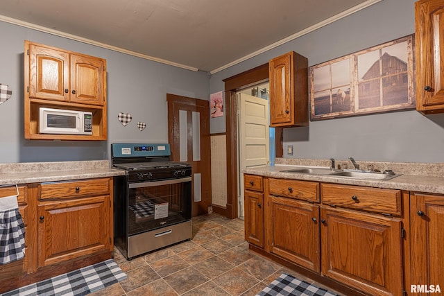 kitchen with crown molding, gas range, and sink