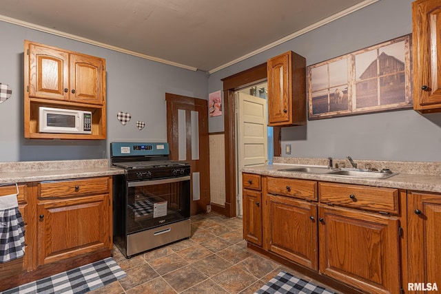 727 N Broadway Ave, Salem, IL 62881 - kitchen with stainless steel gas stove, white microwave, a sink, crown molding, and light countertops