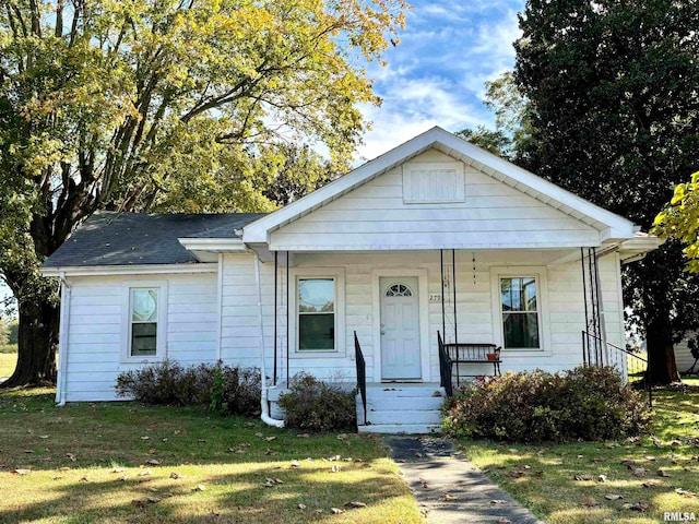 view of front of home with a front yard and covered porch