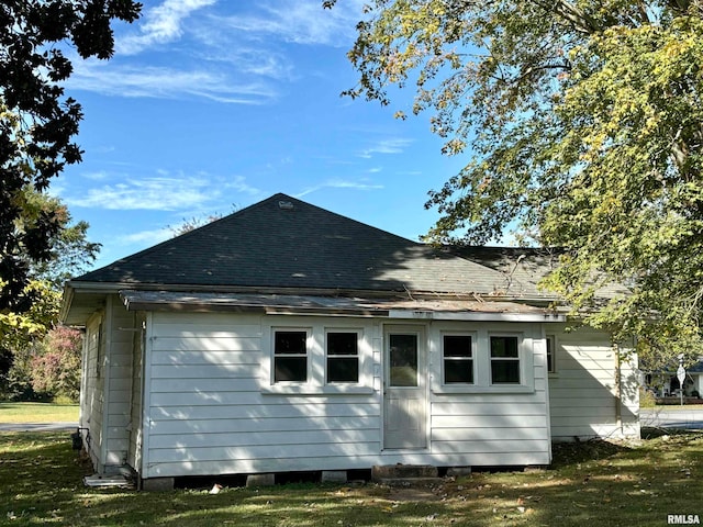 view of side of home with a yard