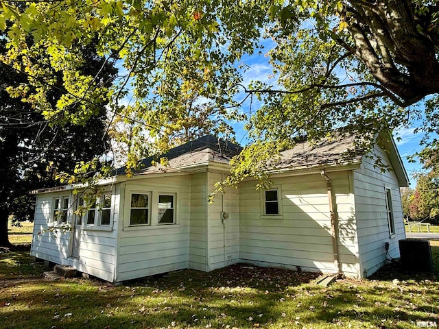 view of side of home with a yard