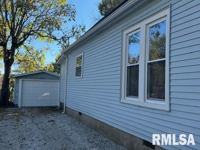 view of side of property with an outbuilding and a garage