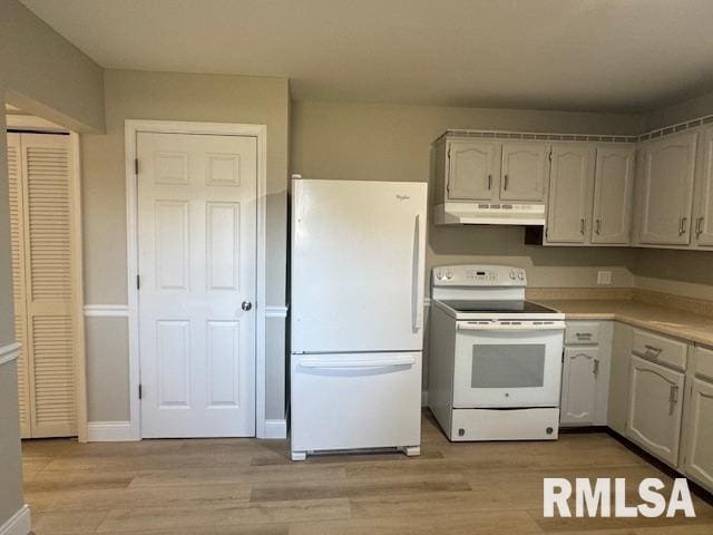 kitchen with light hardwood / wood-style flooring and white appliances