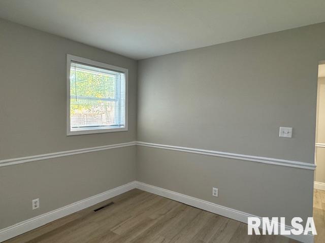 unfurnished room with light wood-type flooring