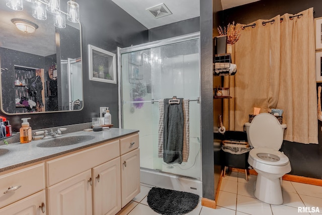 bathroom featuring vanity, tile patterned flooring, toilet, and walk in shower