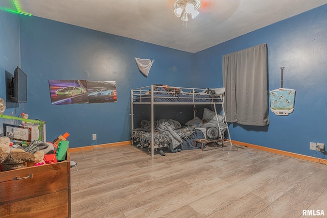 bedroom featuring light wood-type flooring and ceiling fan