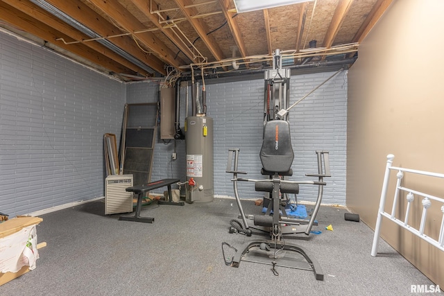 basement with water heater, brick wall, and carpet