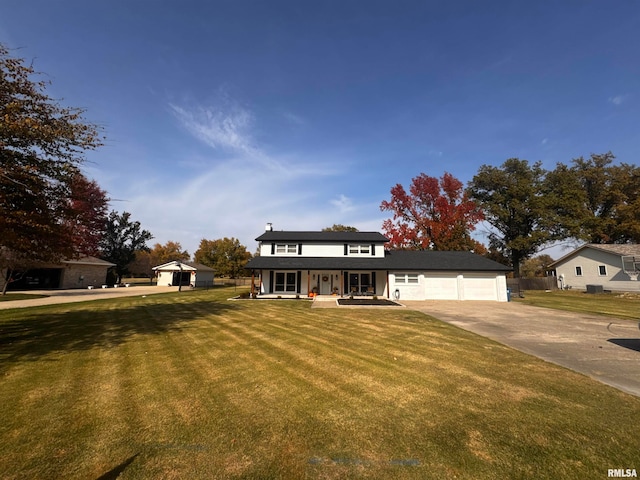 view of front facade featuring a garage, a front lawn, and a porch