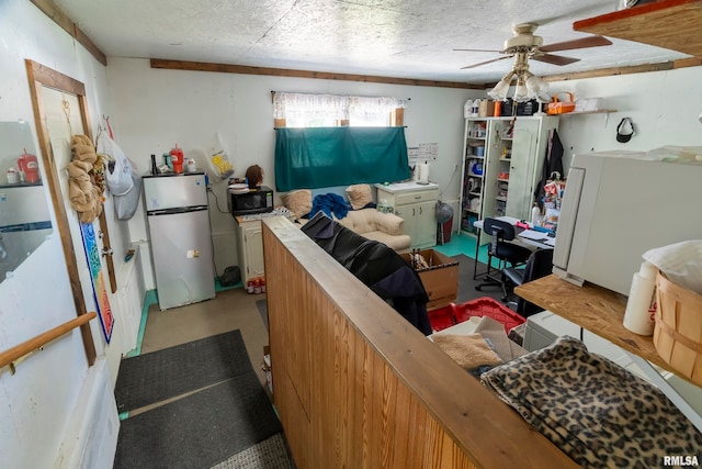 interior space featuring fridge, white fridge, and ceiling fan