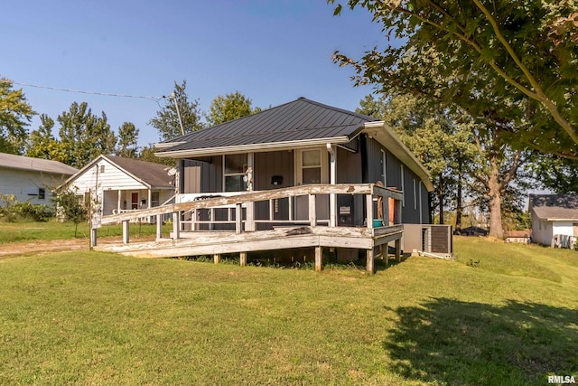 rear view of property with a lawn