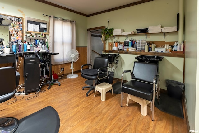 interior space featuring ornamental molding, wooden walls, and light hardwood / wood-style flooring