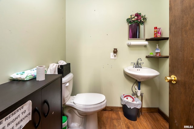 bathroom with hardwood / wood-style flooring and toilet