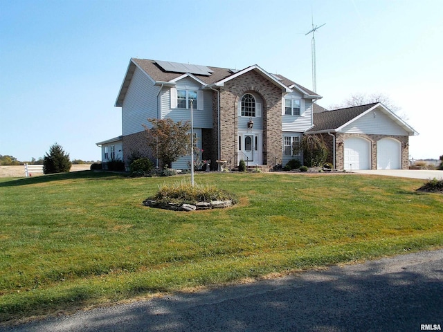 front of property featuring a garage, a front lawn, and solar panels